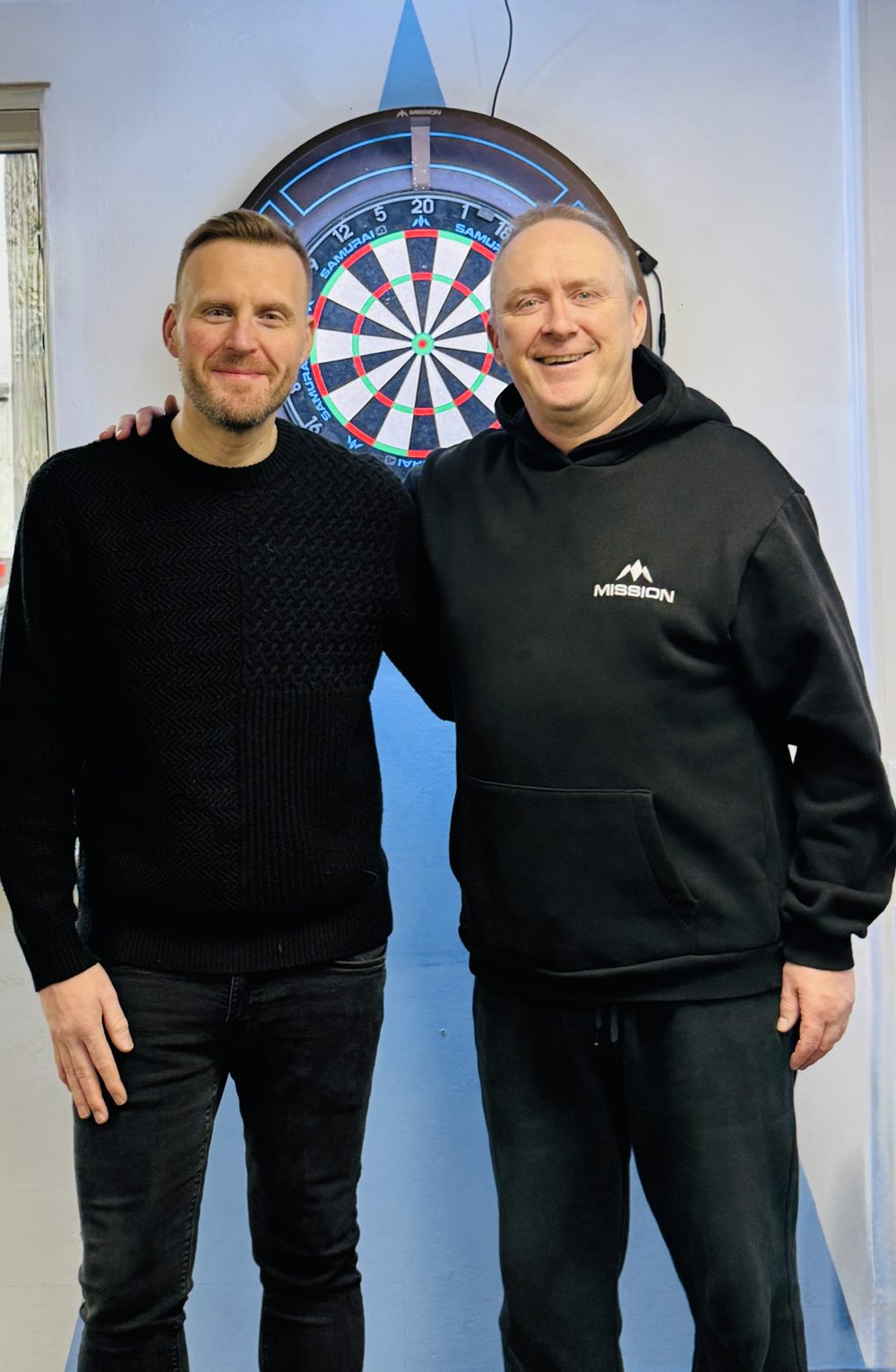 Mark Adams with darts coach Andy Cornwall in front of a dartboard
